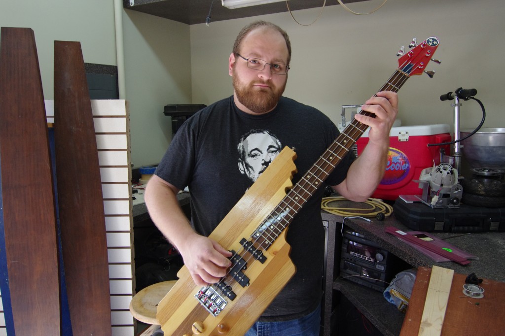 Brian Allen, a senior Commercial Music student at TSU, shows off the bass guitar he built as a senior project using the seven native woods of Tennessee. (photo by Rick DelaHaya, TSU Media Relations)