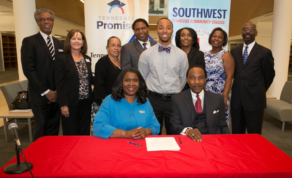 President Glenda Glover, left, and President Nathan Essex, of Southwest Tennessee Community College, sign the Student Transfer Partnership Agreement. Witnessing the ceremony are, standing from left, Dr. John Cade, Vice President for Enrollment Management and Student Support Services; Karen F. Nippert, Southwest VP for Institutional Advancement; Dr. Sharon Peters, Director of Community College Initiative; Dr. Mark Hardy, Vice President for Academic Affairs; Southwest student Reginald Deon Woods; Barbara Roseborough, Southwest Provost and Executive Vice President; and Dr. Alisa Mosley, Associate Vice President for Academic Affairs. (photo byJohn Cross, TSU Media Relations) 