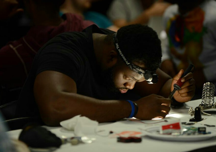 Myron Sallie, a junior Architectural Engineering mojor, conducts a soldering experiment during Hack Nashville, an event that brought computer programmers and coders together to collaborate on innovative products during the course of a weekend.