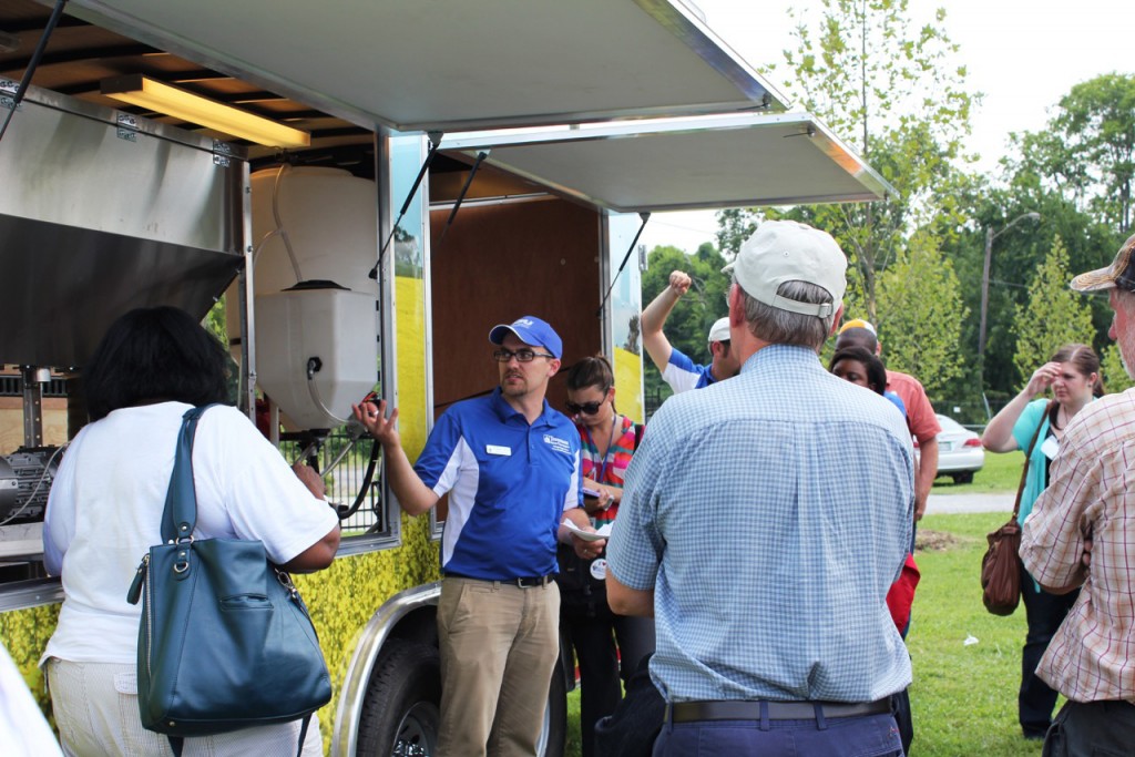 Dr. Jason de Koff (center), assistant professor of agronomy and soil sciences at TSU, shares bioenergy research with visitors recently. The mobile demonstration lab will be on display throughout the year beginning March 9. (courtesy photo)