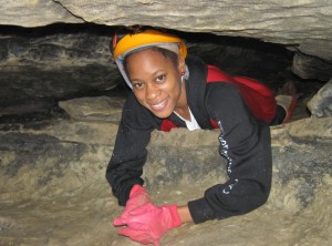 JeTara crawling thru cave to sample site