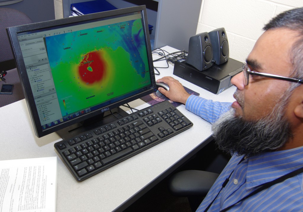 Dr. Muhammad Akbar, assistant professor of Mechanical and Manufacturing engineering, reviews satellite imagery from Hurricane Katrina from 2005. Akbar recently received a grant from the National Science Foundation to conduct research on a simulation model that would help predict storm surge from approaching hurricanes. (photo by Rick DelaHaya, TSU Media Relations) 